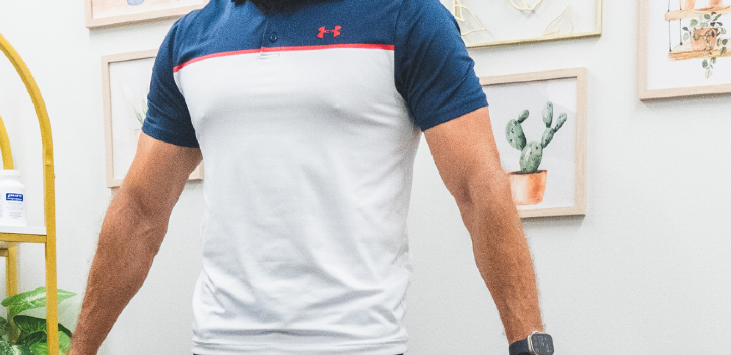 Man standing on an InBody scale for a body composition scan while a provider observes, during a medical weight loss consultation at Leawood Total Wellness.